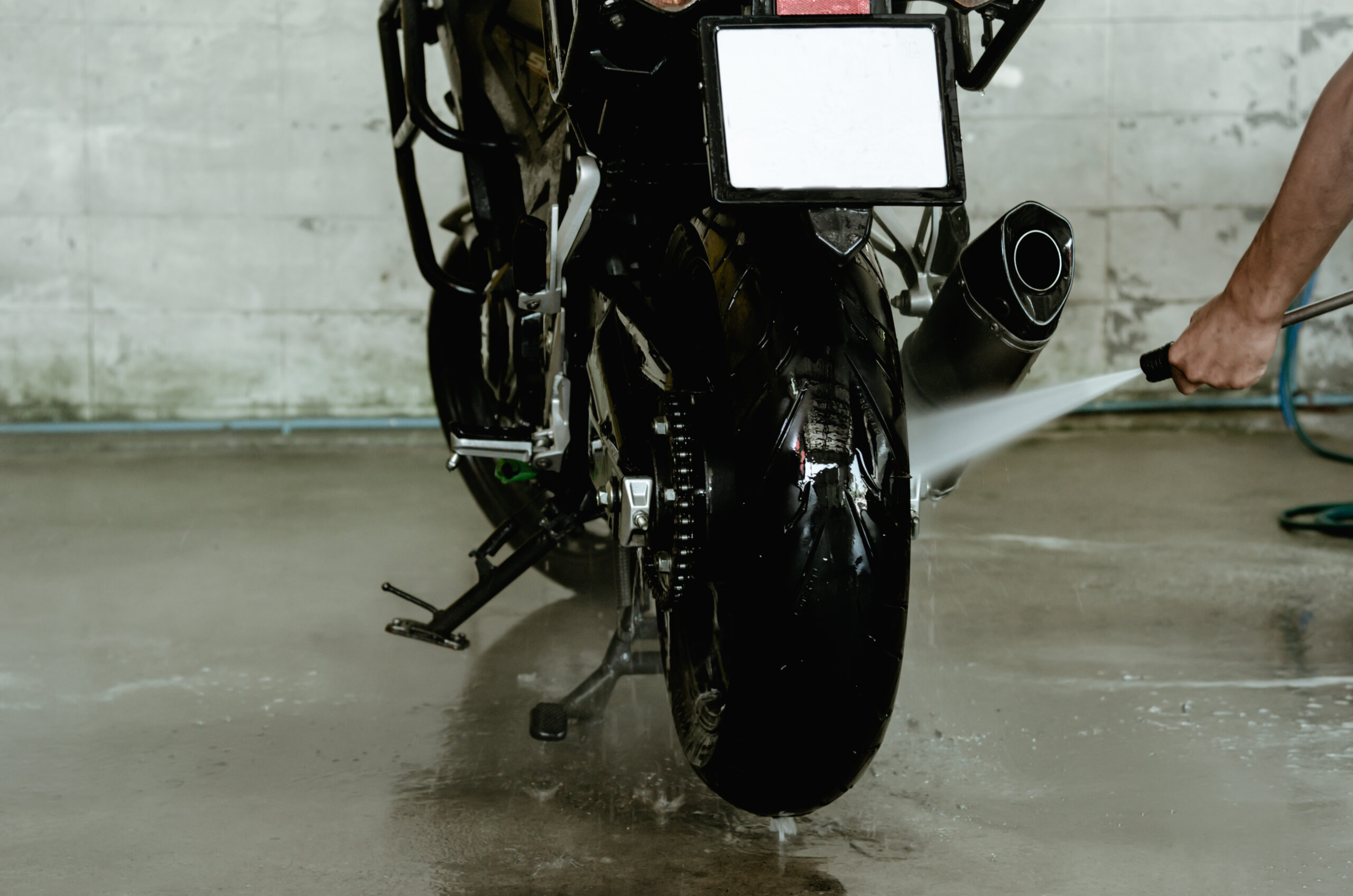 High-pressure water gun wash the motorcycle at the car wash shop