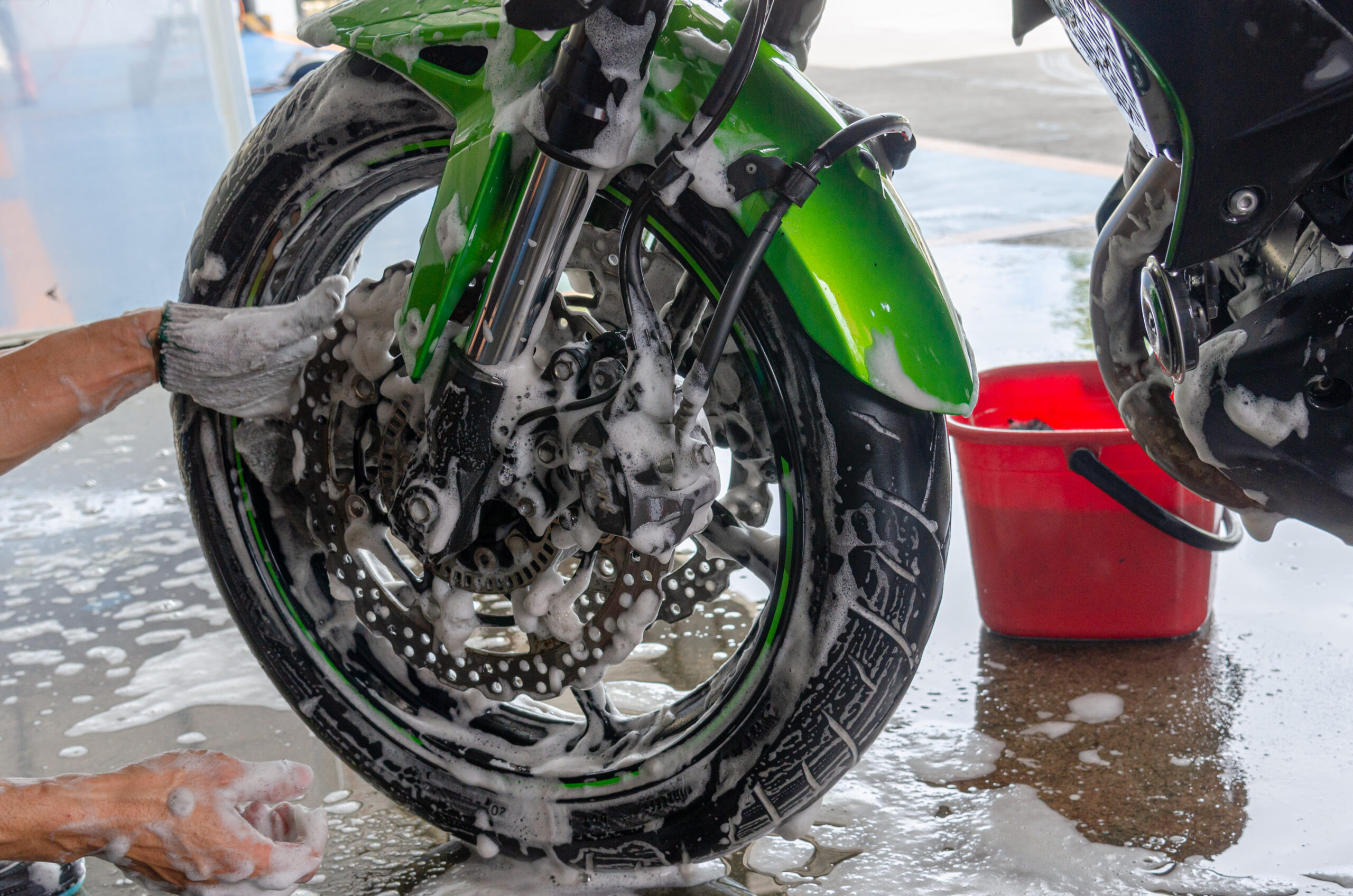 Wash the motorcycle at the car wash.
